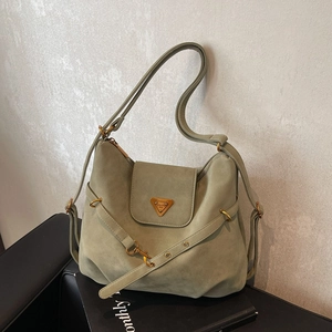 Green faux suede shoulder bag with gold triangular logo and adjustable strap for women