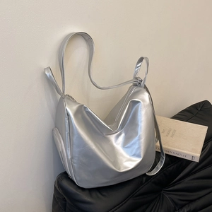 Silver pleated tote bag with adjustable strap and metallic finish for daily commuting