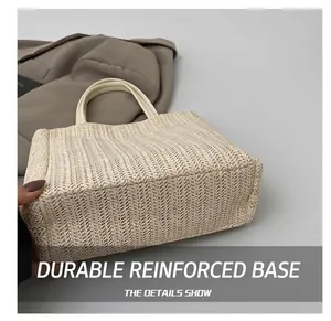 Close-up of woven straw tote bag detail showing texture and durable bottom structure