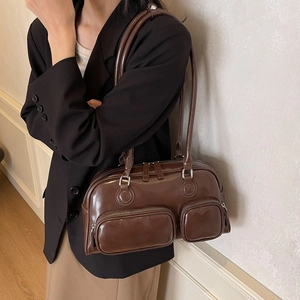 Vintage brown glossy bowling shoulder bag with multiple pockets for daily commuting