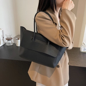 Chic black large capacity tote bag with lychee pattern leather shown on a model