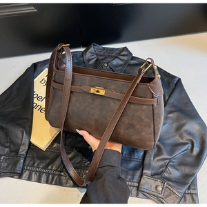 Dettaglio della borsa a spalla marrone scuro vintage con finitura opaca e fibbia oro
