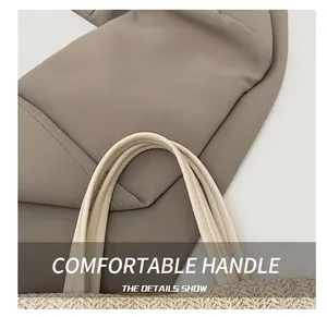 Detailed close-up of smooth synthetic leather handle and handwoven straw tote texture