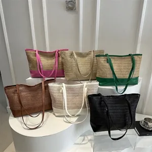 Minimalist straw tote bag with faux leather contrast trim for summer beach vacation