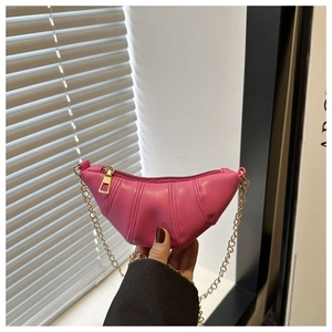 Détail du mini sac croissant rose fuchsia avec plis verticaux et chaîne dorée