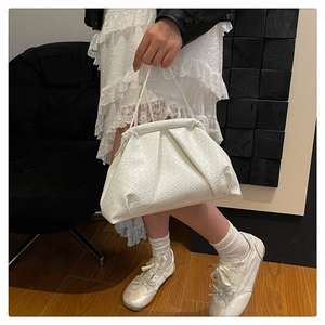 Detailed view of the woven leather cloud bag with soft pleats and a thin shoulder strap
