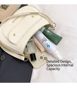 Interior view of off-white leather saddle bag showing large capacity for essentials