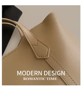 Detailed close-up of stitching and khaki leather texture on this stylish tote bag