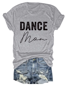 Flat lay of grey crew neck Dance Mom t-shirt with distressed denim shorts on white background