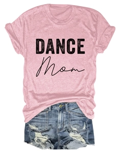 Flat lay of pink 'DANCE MOM' t-shirt paired with frayed blue denim shorts on white background