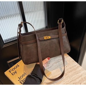 Dettaglio della borsa a tracolla marrone vintage con chiusura dorata e texture opaca