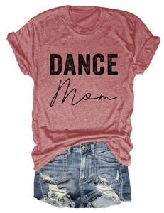 Flat lay of a red DANCE Mom t-shirt and distressed denim shorts with frayed edges