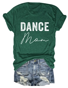 Close-up of DANCE MOM print on dark green t-shirt paired with distressed denim shorts