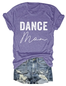 Flat lay of purple cotton T-shirt featuring white DANCE Mom graphic print and denim shorts