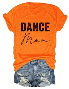 Close-up of bright orange DANCE Mom T-shirt paired with distressed blue denim shorts