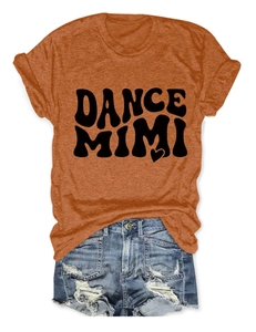 Flat lay of women's orange crew neck t-shirt with black printed logo and ripped denim shorts