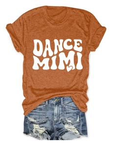 Close-up of orange cotton t-shirt with heart graphics and ripped denim shorts