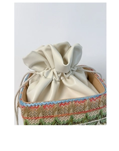 Detail of colorful woven straw bag with cream leather drawstring closure and blue trim
