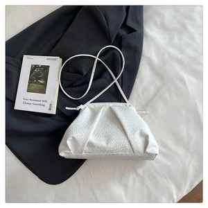 Detailed view of the white woven leather cloud bag with premium braided texture