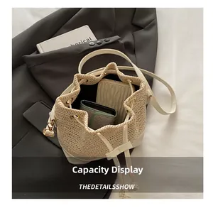 Détail intérieur du sac seau en paille tressée montrant la capacité de rangement