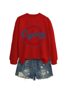 Detail of red crewneck sweatshirt with blue baseball graphic and distressed denim shorts
