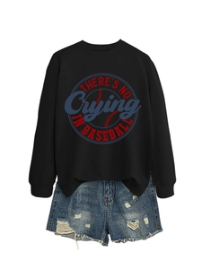 Detail of black baseball sweatshirt with circular graphic print and distressed denim shorts