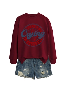 Detail of burgundy baseball sweatshirt paired with distressed denim shorts