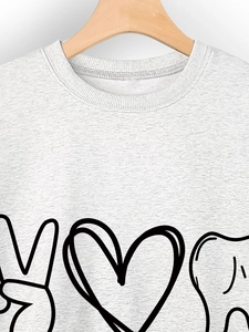 Close-up of peace love dental graphic print on grey crewneck sweatshirt texture