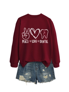 Detail of burgundy dental theme sweatshirt with peace, love, tooth graphics and denim shorts