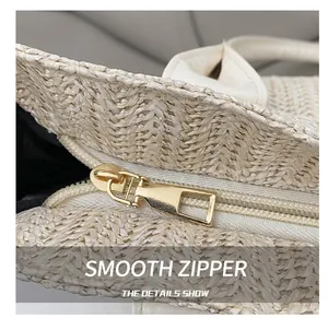 Detailed macro view of straw bucket bag with smooth golden zipper and leather handle