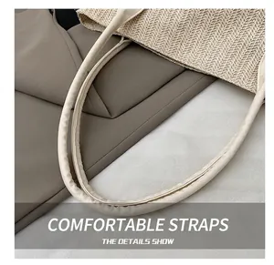 Detail of a beige woven tote bag showing the textured straw pattern and smooth round strap