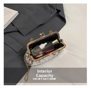 Detailed view of silver sequin clutch bag interior holding lipstick and cosmetics