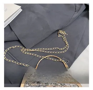Detailed view of luxury evening bag with gold sequins and durable metal chain hardware