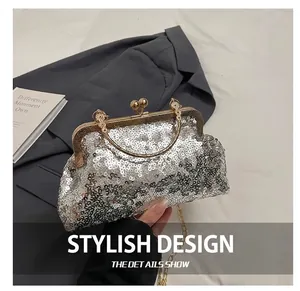 Detailed shot of silver sequin evening bag with gold metal clasp and beaded handle