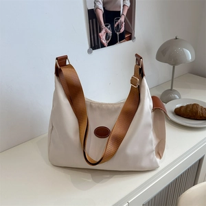 Large beige nylon tote bag with brown adjustable strap and side pocket for casual wear