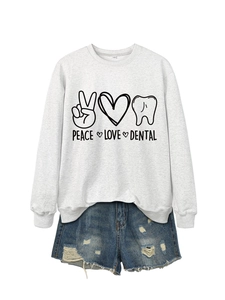 Detail of grey sweatshirt with Peace Love Dental graphic and frayed denim shorts