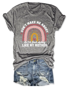 Flat lay of gray graphic tee and distressed denim shorts with frayed edges detail