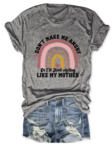 Flat lay of gray humor quote t-shirt with rainbow print and distressed denim shorts set