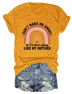 Close-up of ginger yellow t-shirt with slogan and distressed denim shorts flat lay