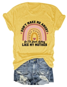 Detail of yellow T-shirt with rainbow graphic and mother quote paired with ripped denim shorts