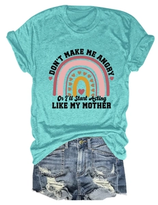 Flat lay of a mint green t-shirt with retro rainbow print and frayed denim shorts set