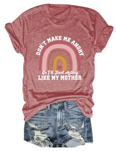 Flat lay of women's casual summer set with rainbow graphic tee and ripped denim shorts