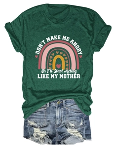 Detail of green slogan t-shirt tucked into distressed denim shorts for a casual look