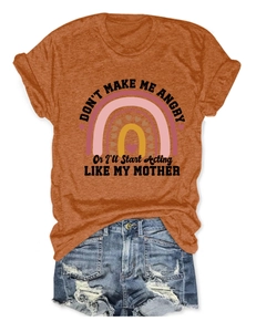 Detail of burnt orange t-shirt with funny Mother quote and retro rainbow graphic