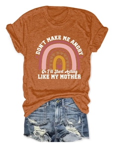 Detailed flat lay of women's orange T-shirt with humorous slogan and denim shorts