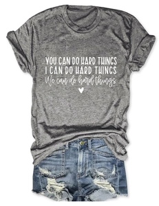 Flat lay of grey t-shirt with you can do hard things slogan and denim shorts
