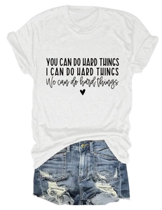 Detail of white cotton T-shirt featuring You Can Do Hard Things text and blue denim shorts