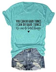 Teal cotton blend crewneck t-shirt with inspirational text paired with distressed denim shorts