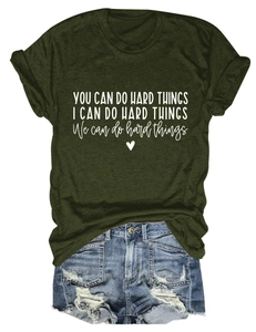 Detail of olive green t-shirt with white text print and frayed denim shorts set