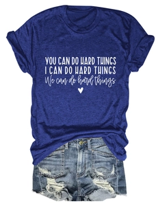 Close-up of You Can Do Hard Things motivational quote and heart print on a blue cotton T-shirt